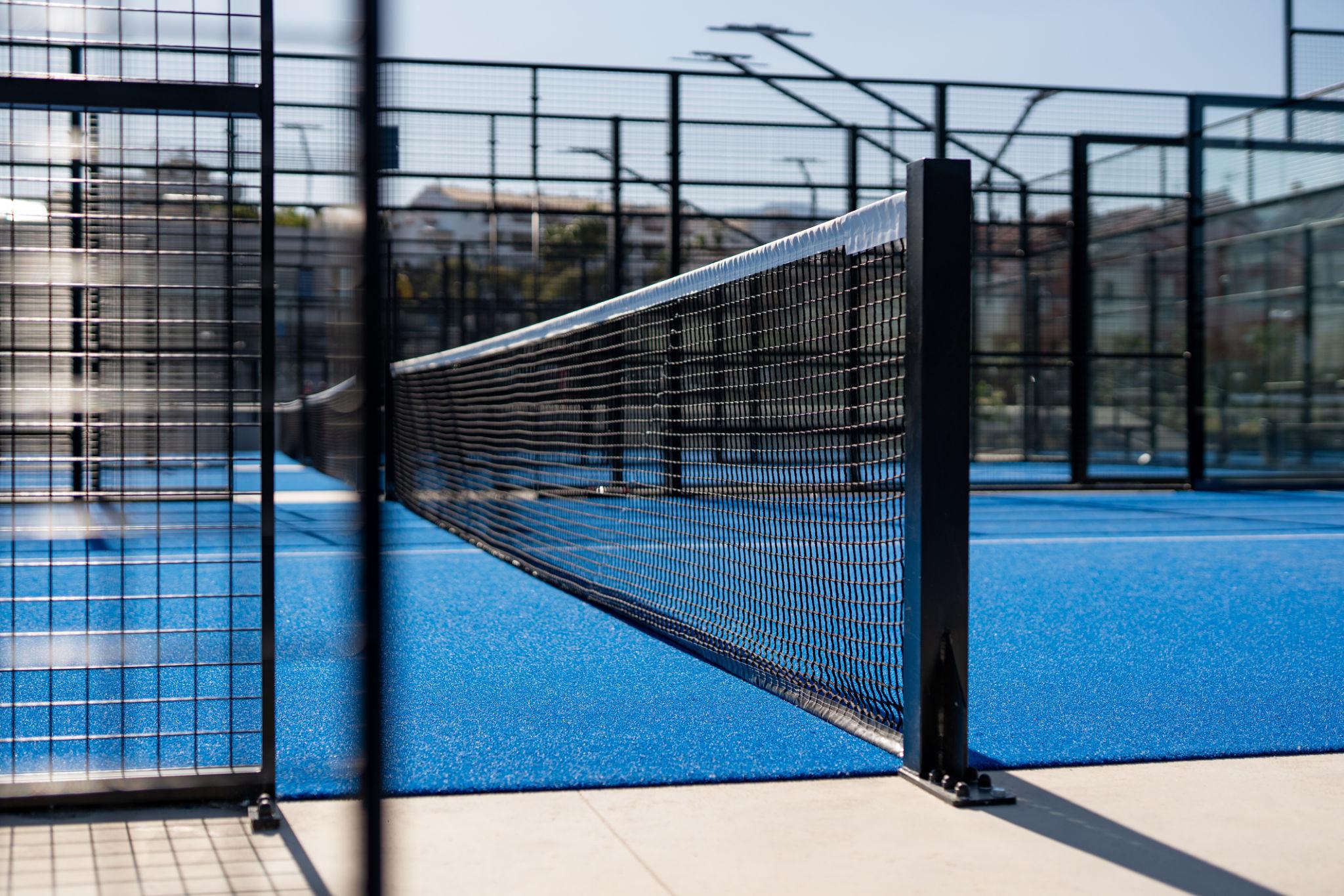 A modern racquet sports venue with multiple outdoor padel courts and supporting facilities